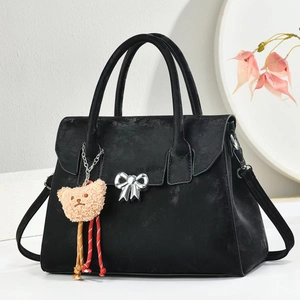 Elegant black suede handbag with silver bow detail and bear charm for women