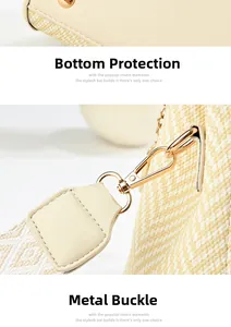Detail of beige leather handbag featuring protective metal feet and woven shoulder strap