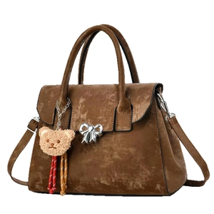Dark brown textured handbag with silver bow clasp and cute bear charm pendant