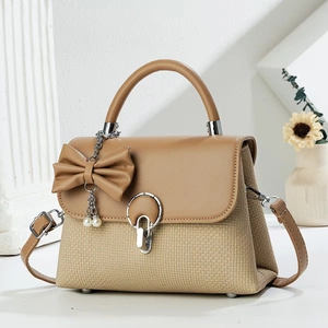 Elegant khaki woven crossbody bag with pearl bow charm and metal ring clasp detail
