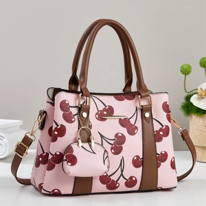 Pink cherry print tote bag with brown handles and a matching mini coin purse keychain