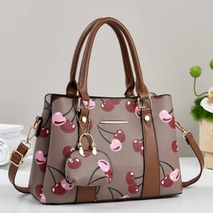 Brown leather tote bag with cherry print and adjustable shoulder strap for women