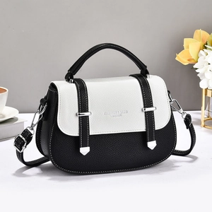 Detail of the high-quality lychee texture and silver buckles on the small square bag