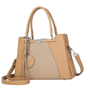 Classic camel tote bag with cat-shaped metal clasp and tassel on white background