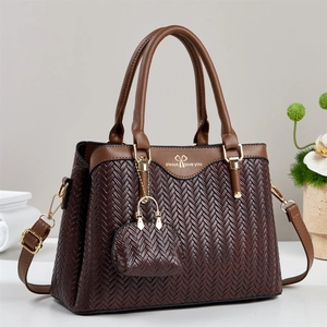 Deep brown woven leather tote bag with stylish top handle and long shoulder strap