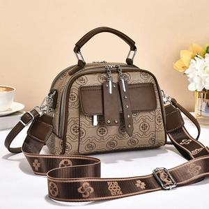 Vintage patterned crossbody handbag with brown leather trim and adjustable strap