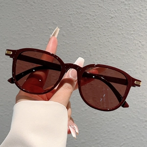 Minimalist oversized round burgundy sunglasses with gold accents for a retro sun protection look
