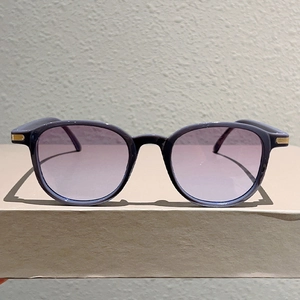 Minimalist oversized round sunglasses with purple gradient lenses and gold metal accents