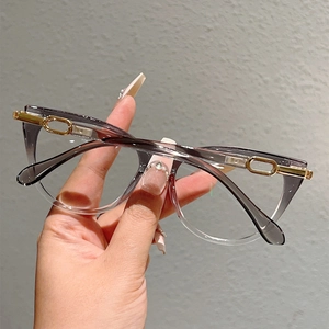 Close-up of elegant cat-eye glasses with purple gradient frames and gold chain detail