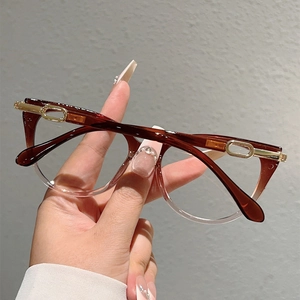 Close-up of cat-eye frames with tea-brown gradient and elegant gold metal accents
