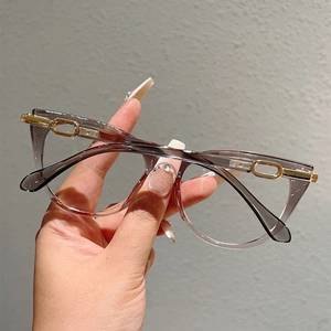 Detail of grey cat-eye frames with golden chain temple decoration and clear lenses