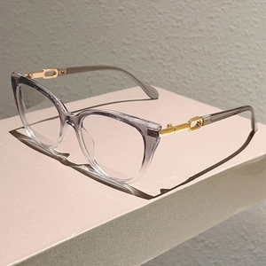 Close-up of cat-eye frames with grey-purple gradient finish and gold metal hinges