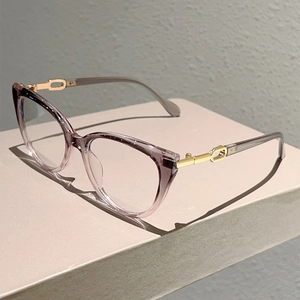 Detail of purple gradient cat-eye frame glasses with golden chain-link metal temples