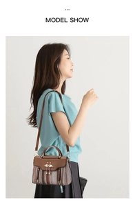 Detail of vintage tote bag with woven texture, swan charm and adjustable strap