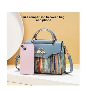 Detailed comparison of striped crossbody bag size next to a pink smartphone