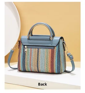 Detail view of the colorful striped woven handbag back showing a functional zipper pocket
