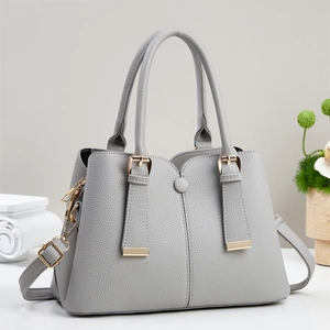 Grey pebbled leather handbag with gold hardware and adjustable strap for women