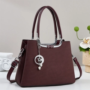 Burgundy textured tote bag with star and moon charm and elegant silver top handle
