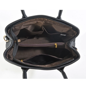 Interior view of black tote bag showing multiple compartments and brown lining