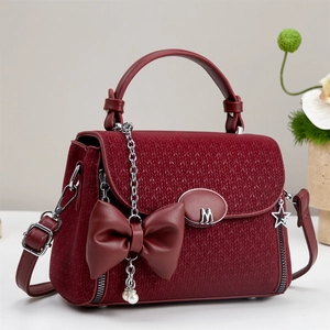 Elegant wine red woven crossbody bag with leather bow and adjustable shoulder strap