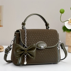 Close-up of olive green crossbody bag with knit texture, pearl chain and M buckle