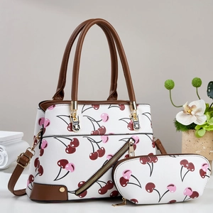 White cherry print handbag set with brown leather straps and gold metal hardware accents