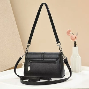 Close-up of black lychee texture leather bag with back zipper and silver hardware details