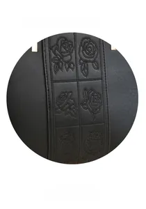 Detail of rose floral embroidery and wide leather handle with golden metal buckle on black bag