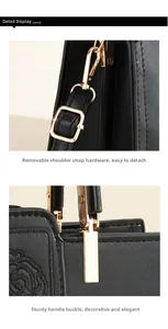 Close-up of black leather bag featuring rose embroidery and golden hardware hooks