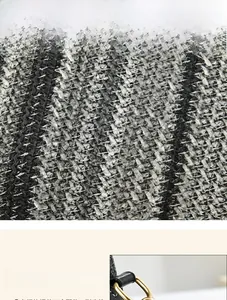 Detail of black and white woven texture with high-quality gold hardware on the handbag