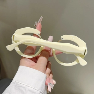 Close-up of cream geometric thick frame glasses with unique 3D polygonal cutting