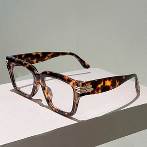 Detail of vintage tortoiseshell frame glasses with three gold metal stripes on temples