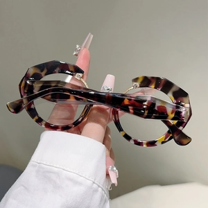 Detail of tortoise shell irregular round frames with layered geometric metal accents