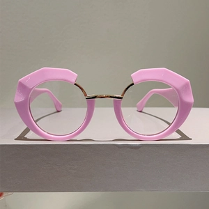 Detailed view of pink geometric round frames with golden metal bridge and asymmetric cut