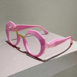 Detail of pink geometric chunky frames with gold metal bridge and modern avant-garde design