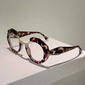 Detail of multi-color tortoiseshell glasses with unique asymmetric frames and gold bridge