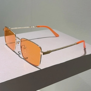 Detail of gold metal twisted rope temple design on orange lens rectangular sunglasses