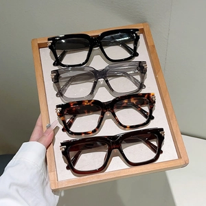 Classic square blue light glasses in four colors with gold metal trim on wooden tray