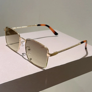 Detailed view of gold metal twisted temple design on stylish square frame sunglasses