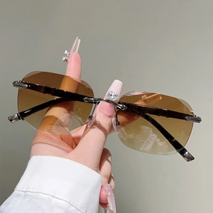 Detail of rimless sunglasses with heart-shaped crystal bridge and bamboo-style metal temples