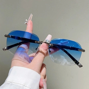 Detail of blue gradient rimless sunglasses with rhinestone accents and metal temples