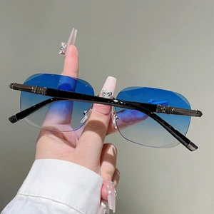 Detail of blue gradient frameless lens and punk metal star carving on the sunglass arm