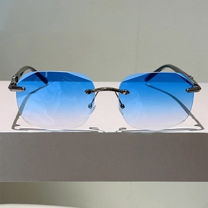 Sleek rimless oval sunglasses with diamond cut gradient blue lenses and silver metal frame