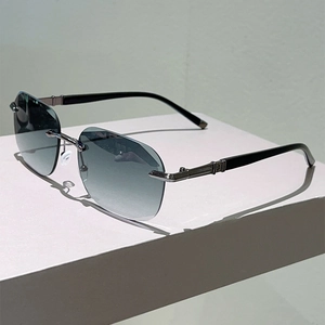 Detail of gunmetal temples with star pattern on rimless gradient blue sunglasses