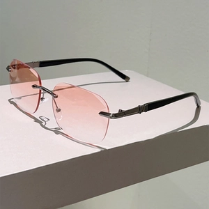 Detail of pink gradient rimless sunglasses with star metal hinge and black temples