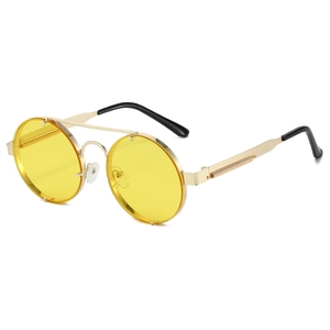 Detail view of steampunk round sunglasses with yellow lenses and metal spring temples