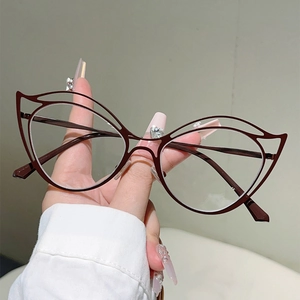 Detail of brown cat-eye metal glasses frame with hollow ear design and anti-blue lenses