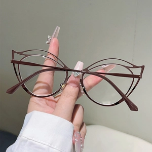 Detailed view of dark brown cat-eye glasses with double-line cutout metal frame