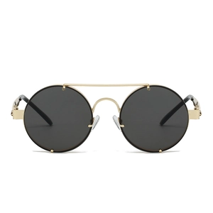 Close-up of steampunk sunglasses with gold metal double bridge and round black lenses
