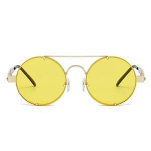 Close-up of retro punk sunglasses featuring yellow lenses and gold metal double bridge